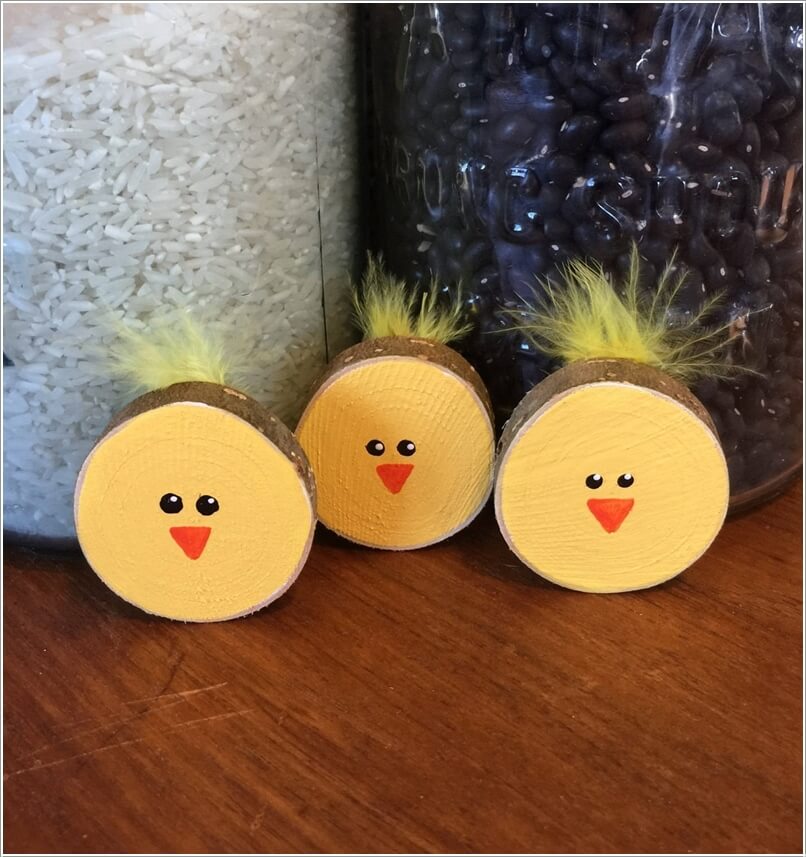 Paint Log Slices with Yellow Paint; Detail Them with Black and Orange Paint for Making Chick Faces and Finish Them with Faux Yellow Feathers